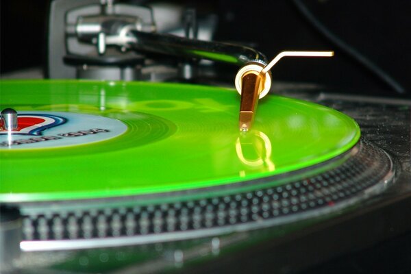 Green vinyl record on the turntable