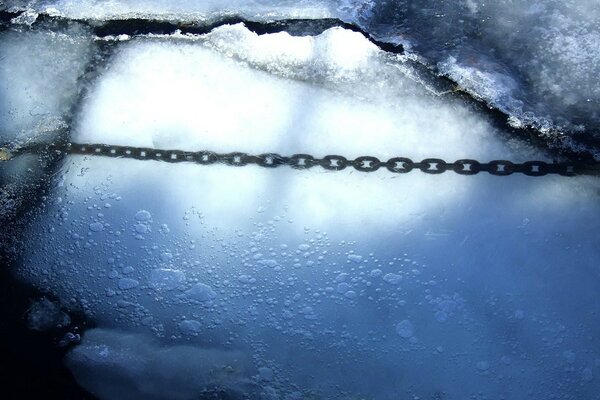 Chain on ice. The river is covered with an ice outgrowth