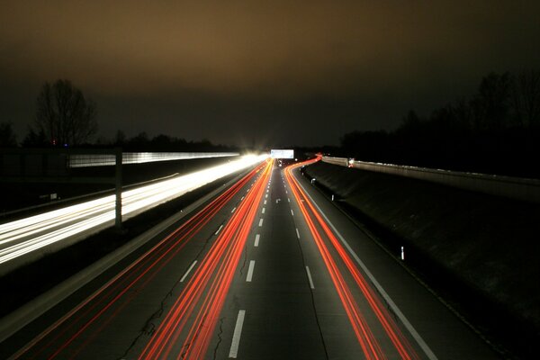 A brightly marked road under the night sky