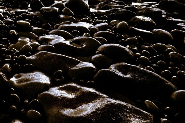 Dark photo of pebbles close-up