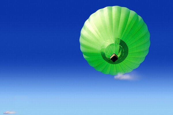 Green balloon on a blue sky background