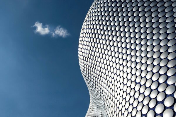 White roundels in a blue sky with a cloud