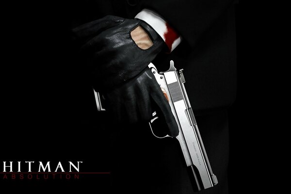 Logotipo del juego Hitman y una pistola en la mano