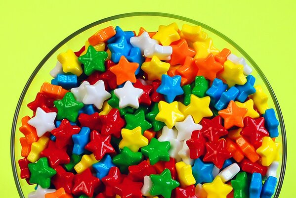 Colorful candies in the form of stars on a plate