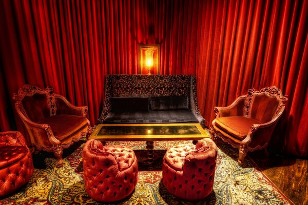 Picture a red room with a sofa and red armchairs