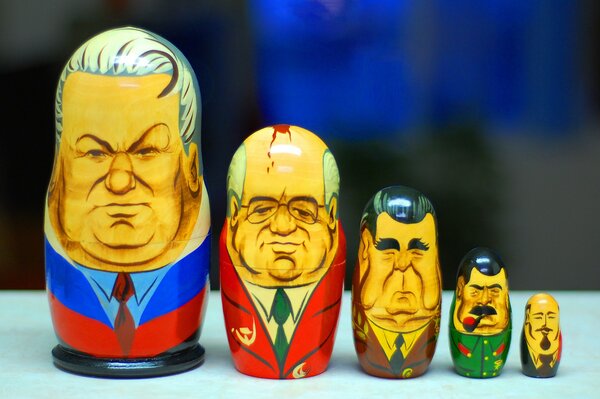 Four matryoshka dolls of the president on the table