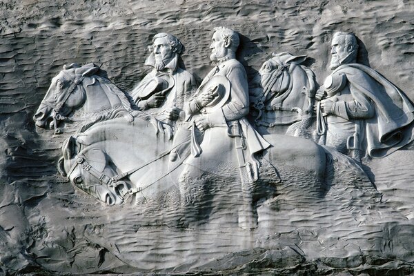 Black and white sculpture in the rock with presidents on the moors