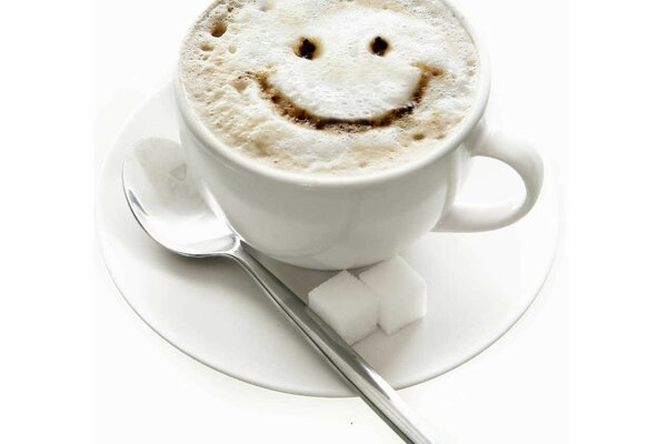 A cappuccino cup with a smiley face on it