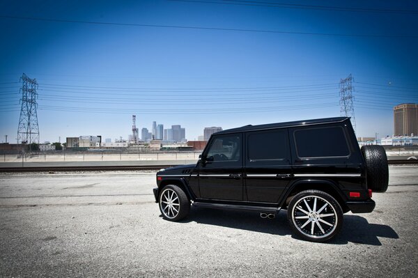 An image of a Mercedes on the background of an urban landscape