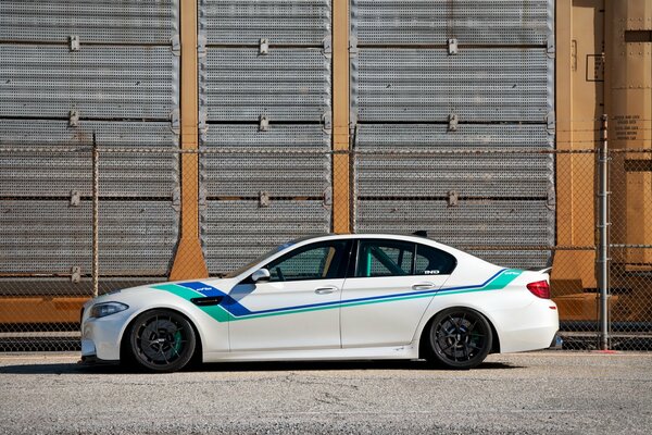 BMW m5 white with multicolored stripes , side view