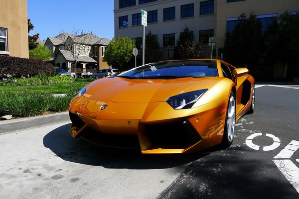 Orange lamborghini aventador among the buildings