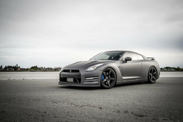 Black, matte Nissan on the background of the river