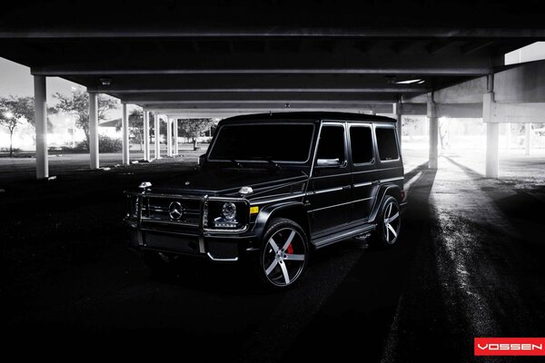 Black Mercedes Benz under the overpass in dark colors