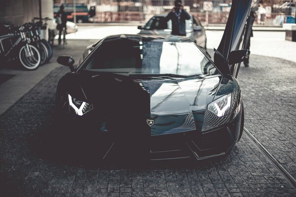 Black Lamborghini Aventador with open door, front view