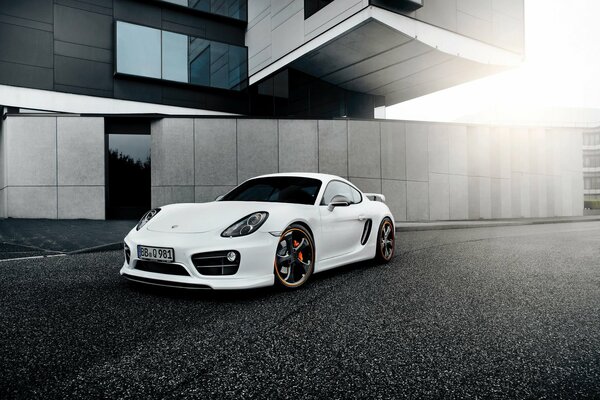 A white sports car near a beautiful building