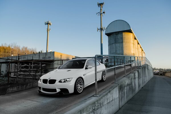 BMW coupé blanco en el paso elevado