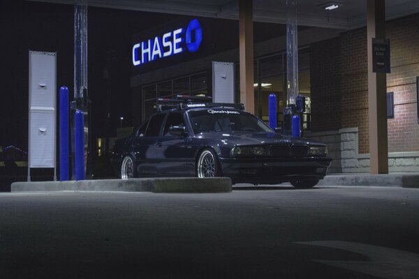 A black car leaves the dealership