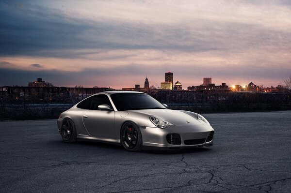 Silver Porsche 911 on the background of the city