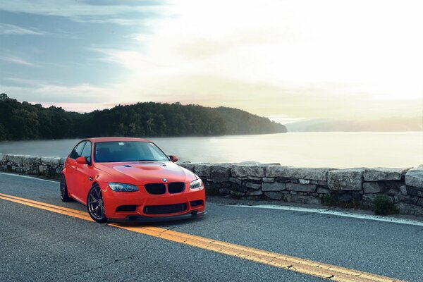 Red BMW on the background of a sea sunset