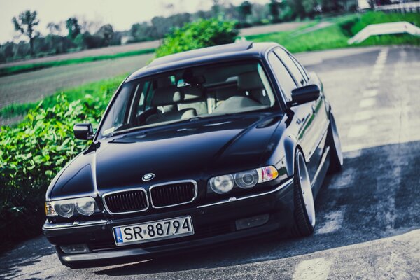 Black BMW car on the road