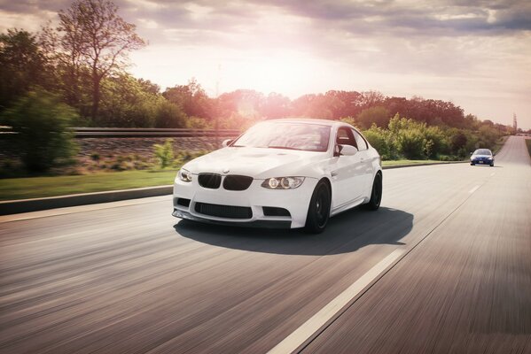 White BMW rushes along the highway