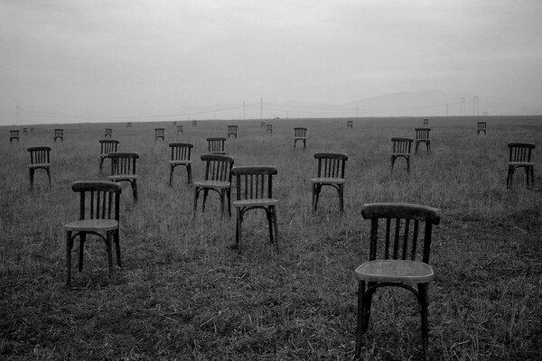 Lonely chairs in an open field