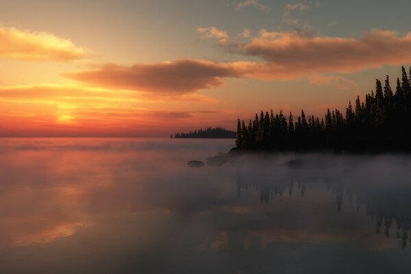 Puesta de sol brumosa sobre el lago