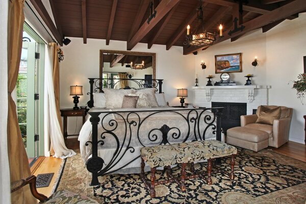 Candles and a carved bed in the bedroom