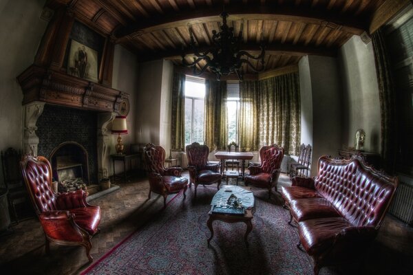 A large room with leather armchairs and a sofa