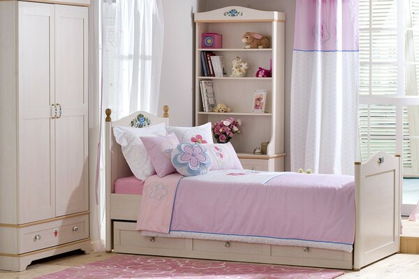 The interior of a pink room with a curtain and a wardrobe