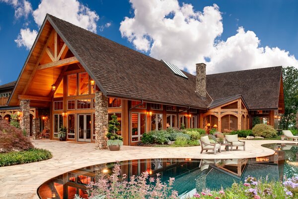 Wooden house with a swimming pool and a stone porch