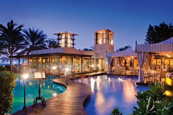 Swimming pool and lanterns in front of a beautiful cafe