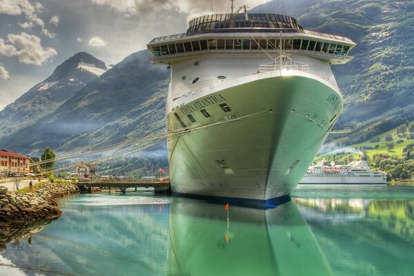 Liner at the pier against the background of mountains