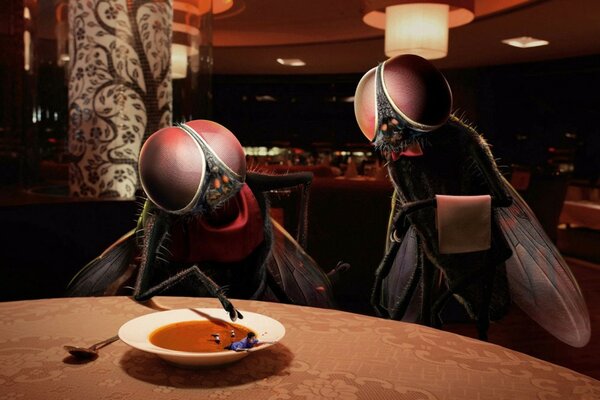 A huge pair of flies have lunch with soup