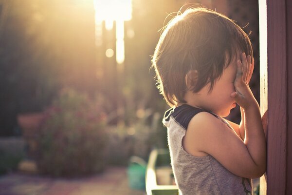 The kid is playing hide-and-seek on the playground