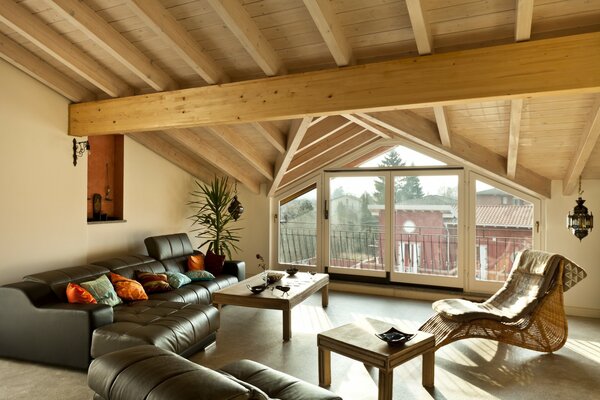 Stylish design of the attic room. Wooden ceiling