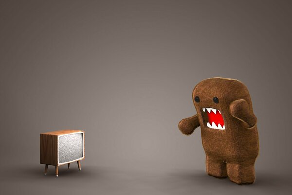 Brown toy in front of the TV