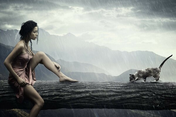 Fille avec un chat sur un arbre sous la pluie