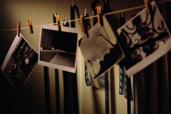 The developed pictures hang on clothespins