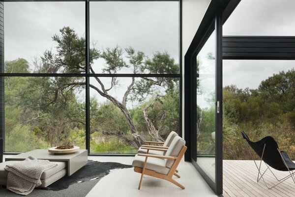 Beautiful view from the window. Chaise longue in front of the table