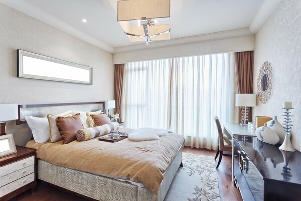 A bed with several pillows in a cozy bedroom