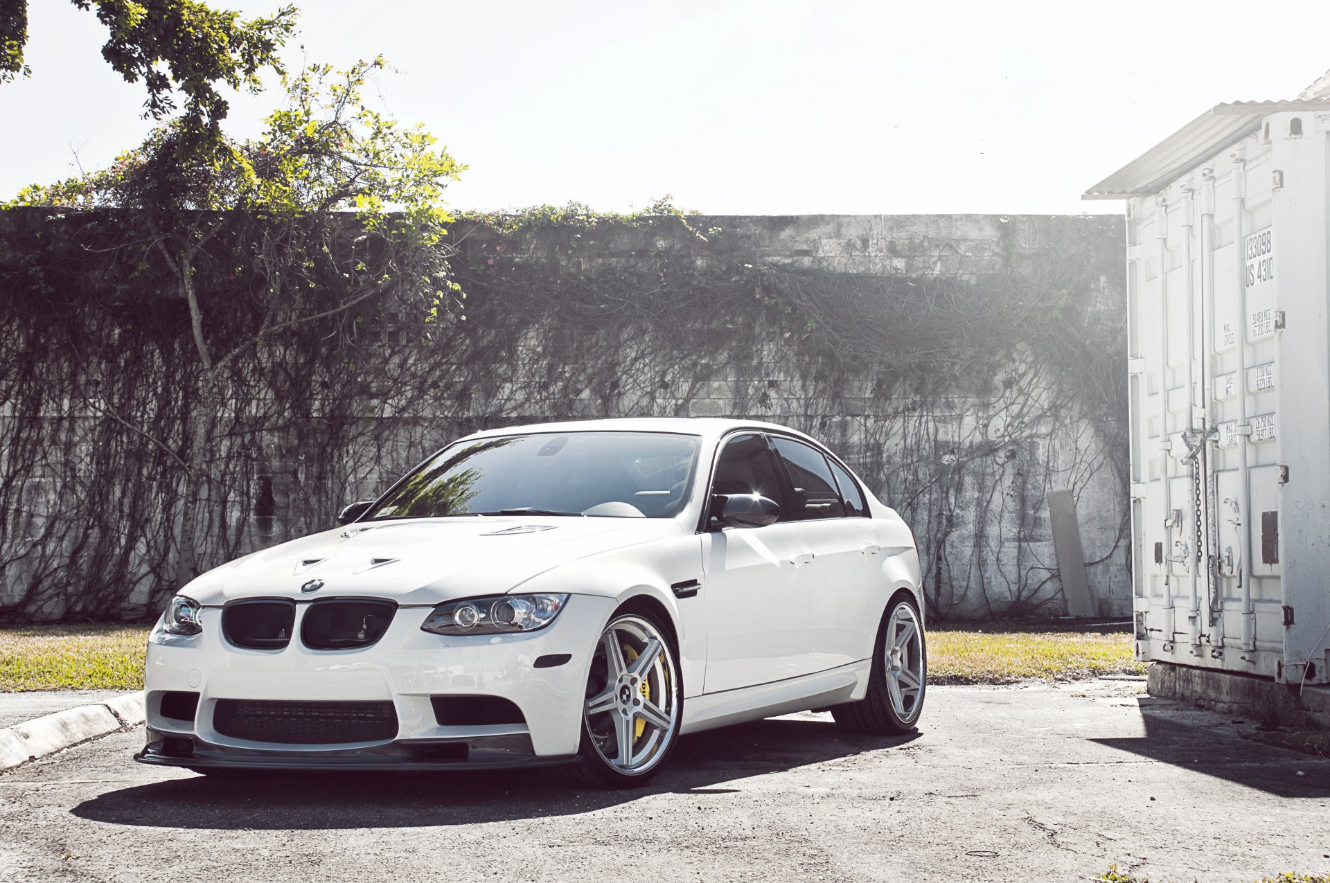 bmw m3 e90 white wheels wood bmw sedan front view fence container