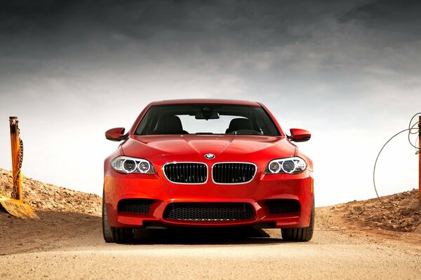 Red bmw, m5 on a deserted road