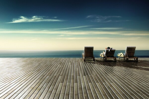 Relaxing on a chaise longue against the sky