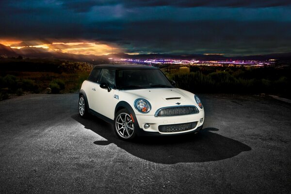 White mini-cooper on the background of the night city