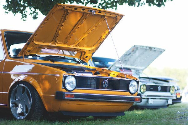 Orange car with open hood