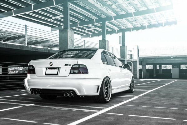 A white BMW of the latest series in the parking lot