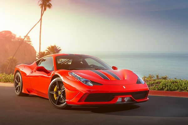 Ferrari rojo contra el mar y las nubes