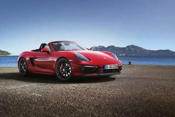 Red Porsche on the background of mountains