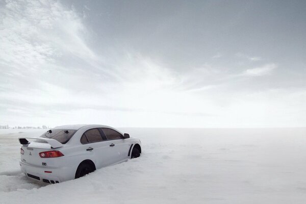 White mitsubishi in white snowdrifts